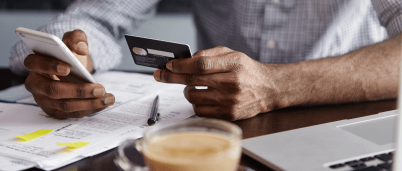 a man paying off credit card debts