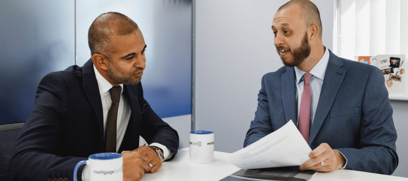 a businessman having a meeting with a mortgage light adviser